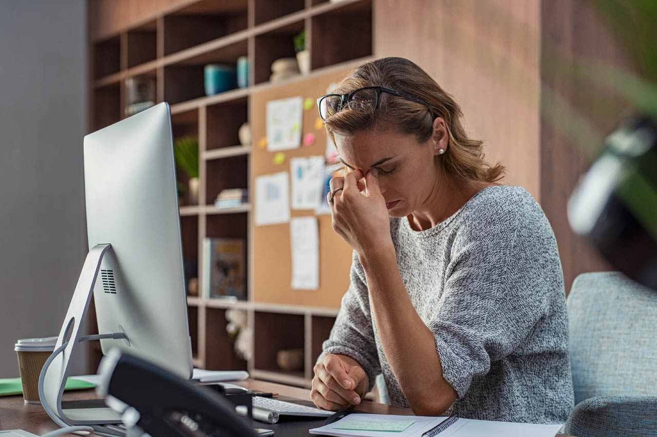 Business woman having headache at office